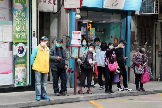 People wearing facemasks waiting for the bus in Chinas. Macau Photo Agency on Unsplash.com