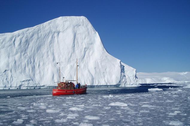 Polar and Russian politics. Red vessel in front of Greenland Iceberg. Photo: Nikolaj Bock/Norden.org
